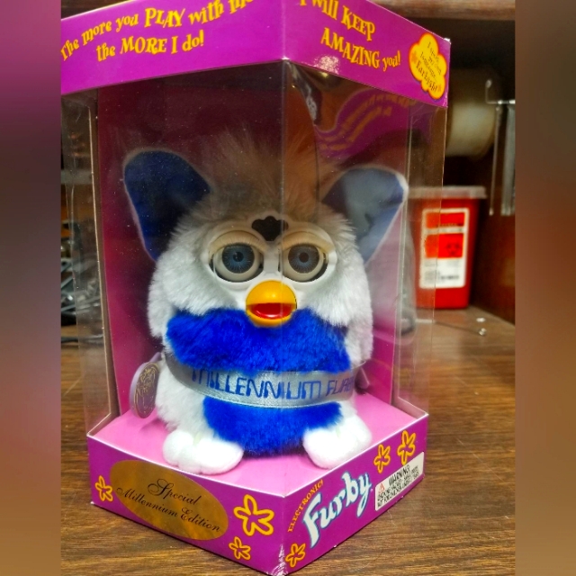 Boxed Millennium edition Furby from the original 1998-2002 run, showing mechanical eyes and the original purple Furby box